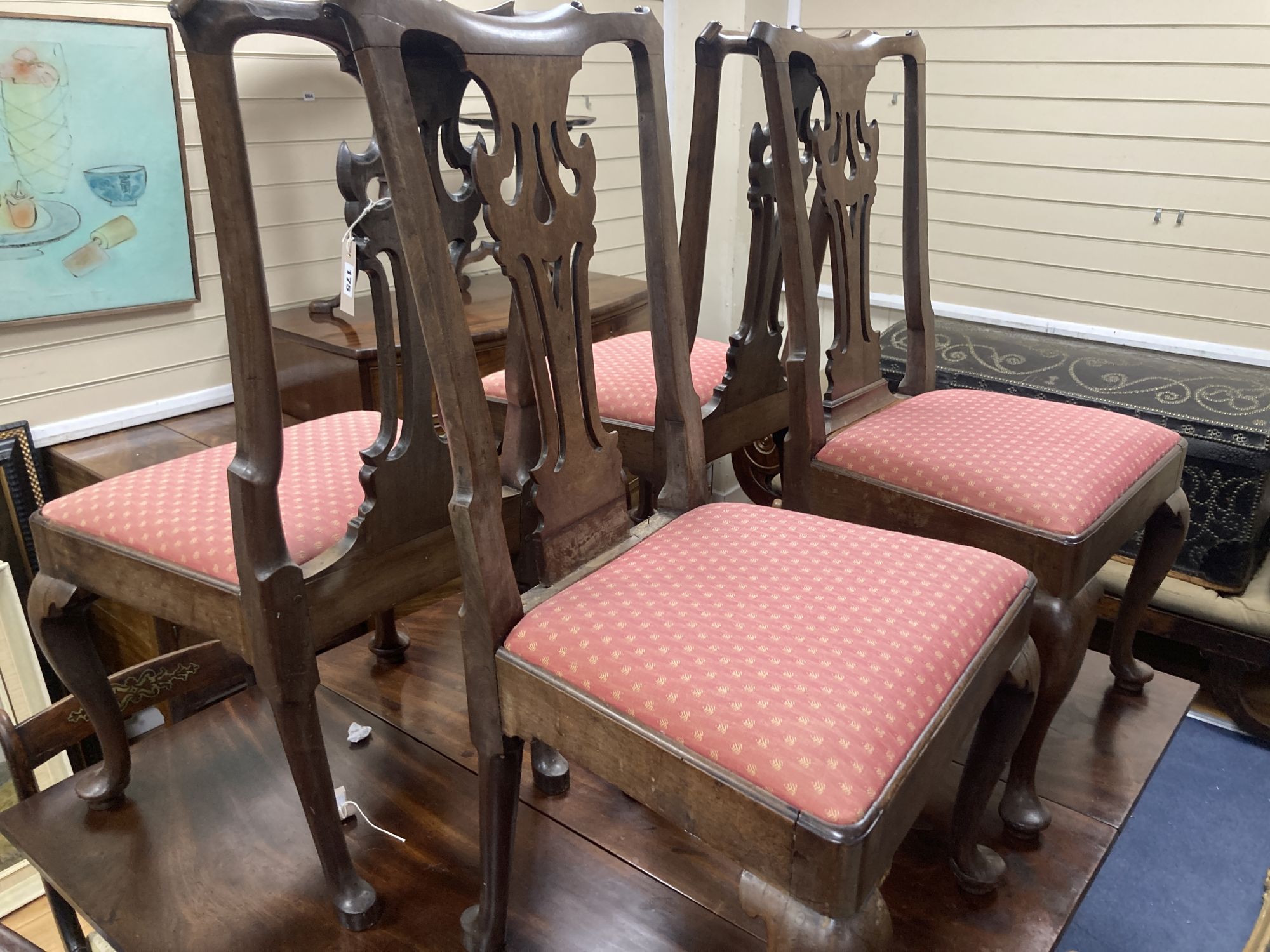 A set of four mid-18th century walnut / mahogany dining chairs